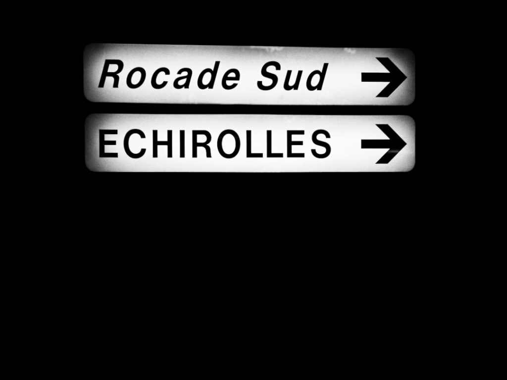 a close up of a street sign with a dark background